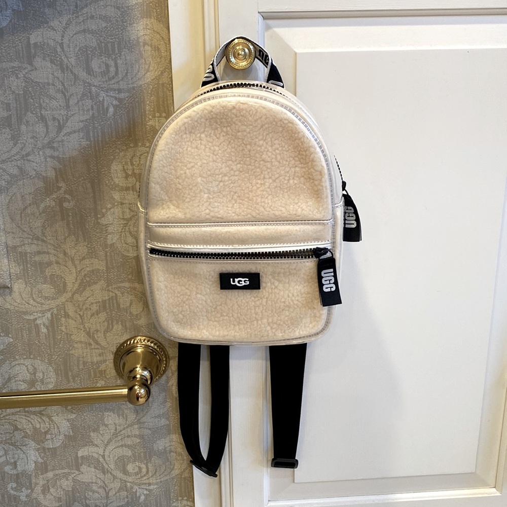 UGG - Pristine, new UGG backpack in cream wool with black logos. Never used.